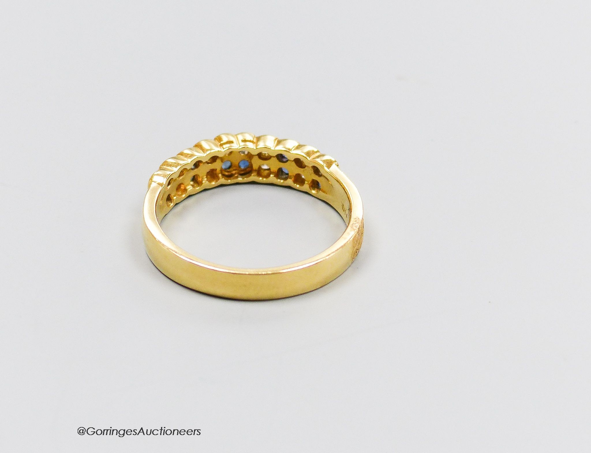 An 18ct gold sapphire and diamond half hoop ring, size R, gross 4g.